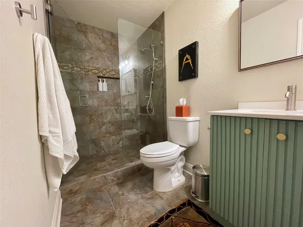 a bathroom with a toilet and a shower