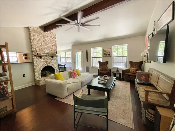 a living room with furniture fireplace and a large window