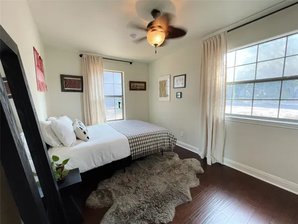 a bedroom with a bed and wooden floor