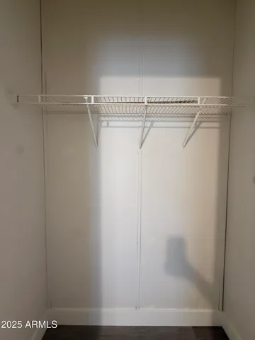 a view of an empty room and wooden floor