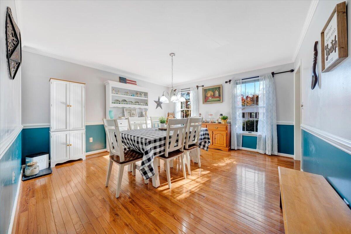 6128 Buckland Mill Road Roanoke, VA 24019 - Photo 20 of 37 a dining room with furniture and wooden floor