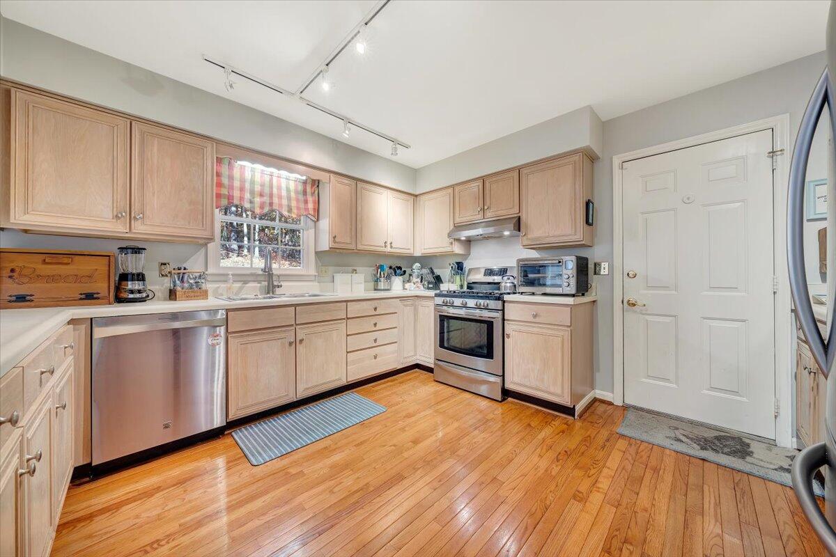 6128 Buckland Mill Road Roanoke, VA 24019 - Photo 26 of 37 a kitchen with granite countertop a sink cabinets and wooden floor