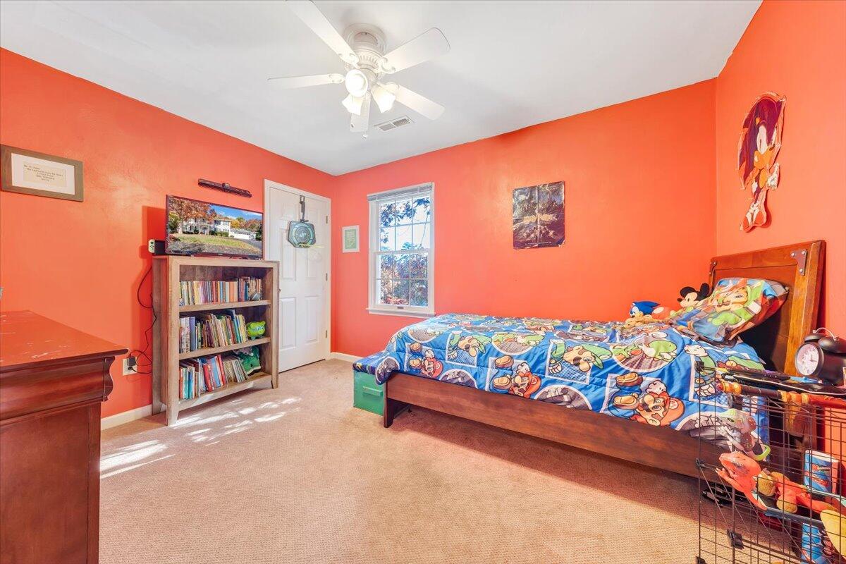 6128 Buckland Mill Road Roanoke, VA 24019 - Photo 30 of 37 a bedroom with a bed and a book shelf