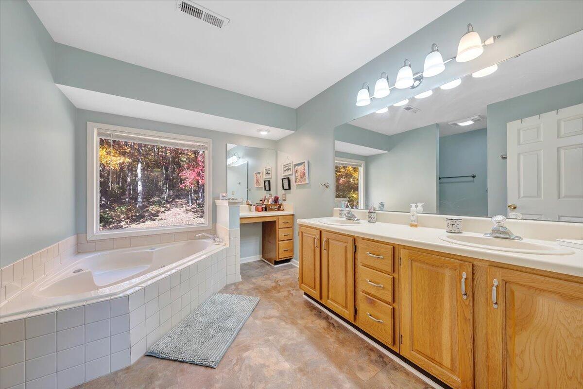 6128 Buckland Mill Road Roanoke, VA 24019 - Photo 34 of 37 a spacious bathroom with a tub a double vanity sink a double vanity and a shower