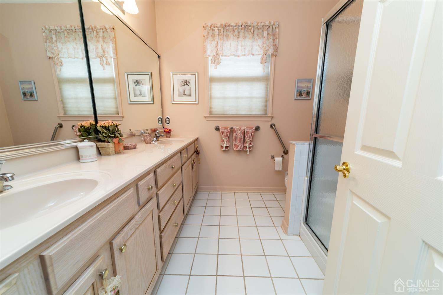 15 Stryker Road Somerset, NJ 08873 - Photo 16 of 24 a bathroom with a sink a mirror and a bathtub