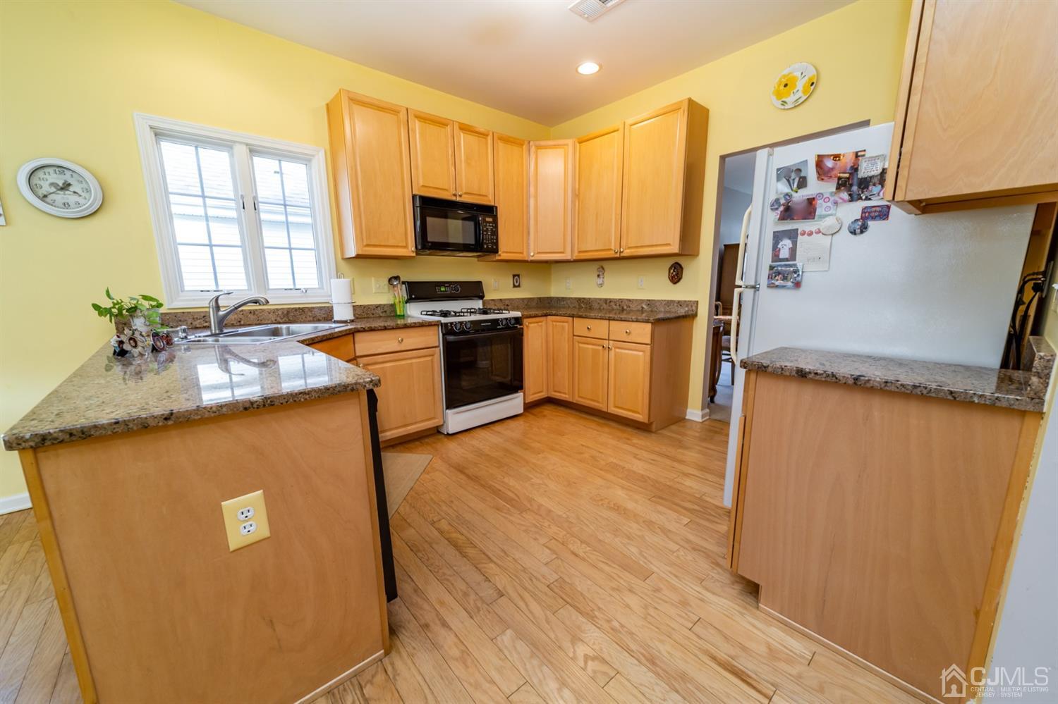 15 Stryker Road Somerset, NJ 08873 - Photo 6 of 24 a kitchen with granite countertop a refrigerator stove top oven and sink
