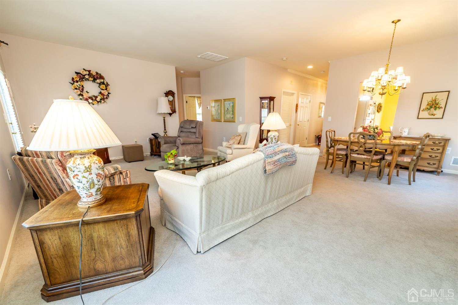 15 Stryker Road Somerset, NJ 08873 - Photo 10 of 24 a living room with furniture and a chandelier