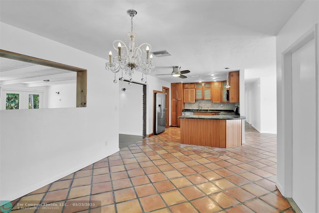 341 Southeast 8th Street Pompano Beach, FL 33060 - Photo 11 of 56 a kitchen with stainless steel appliances kitchen island granite countertop a refrigerator and a sink
