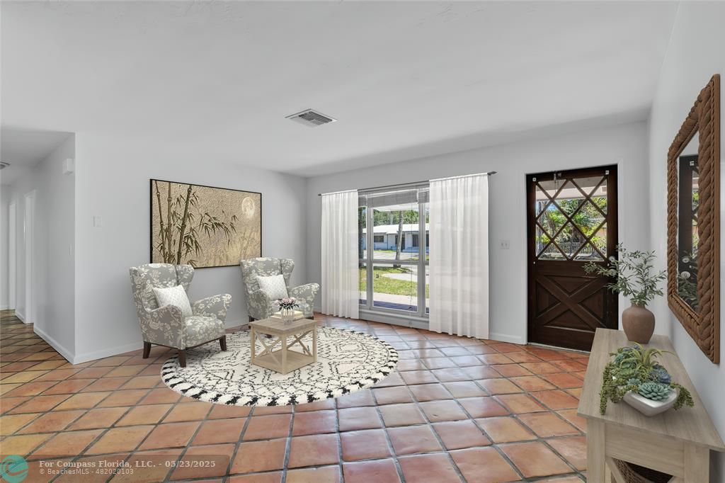 341 Southeast 8th Street Pompano Beach, FL 33060 - Photo 13 of 56 a living room with furniture and a floor to ceiling window