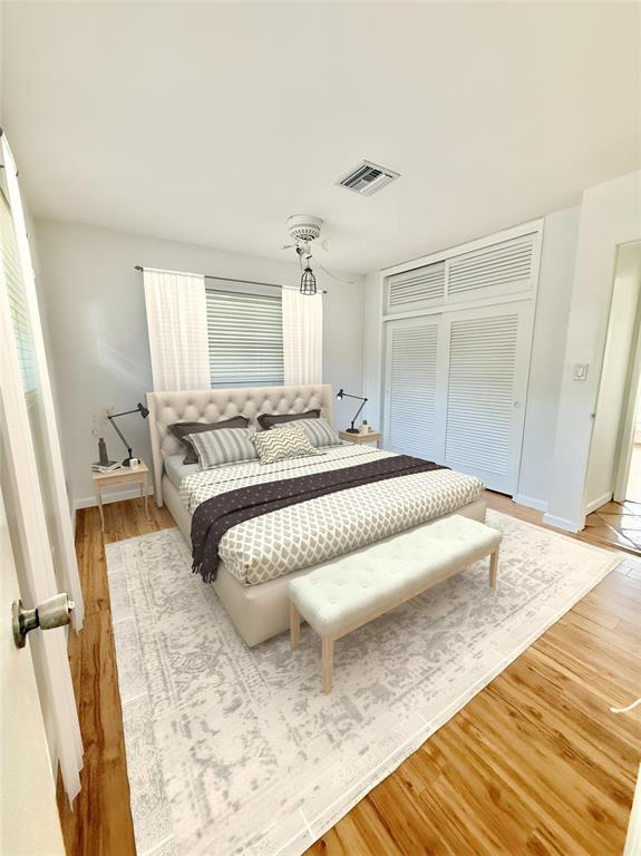 341 Southeast 8th Street Pompano Beach, FL 33060 - Photo 16 of 56 a bedroom with a bed and wooden floor