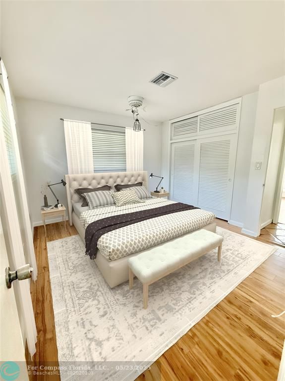 341 Southeast 8th Street Pompano Beach, FL 33060 - Photo 16 of 56 a bedroom with a bed and wooden floor