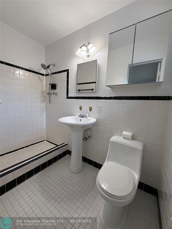 341 Southeast 8th Street Pompano Beach, FL 33060 - Photo 19 of 56 a bathroom with a toilet sink and mirror