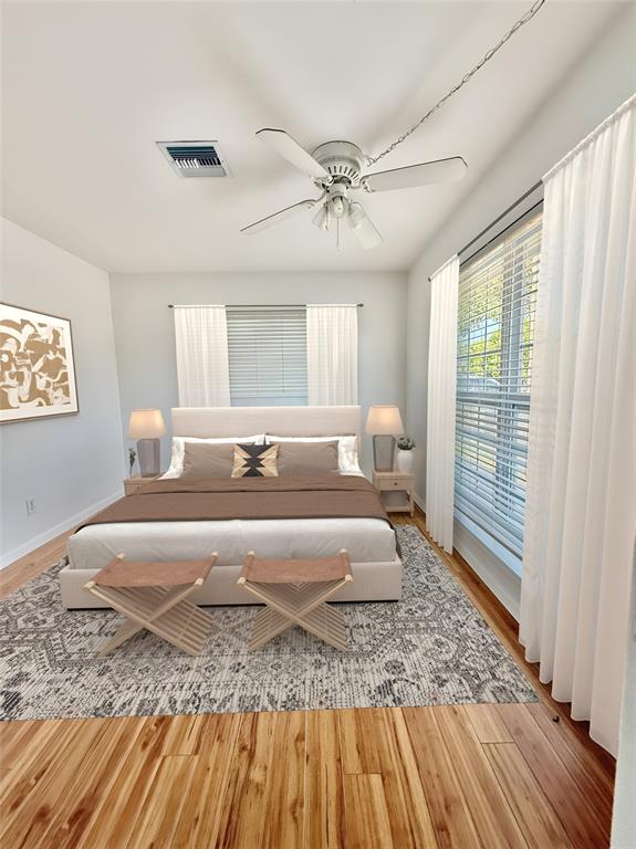 341 Southeast 8th Street Pompano Beach, FL 33060 - Photo 20 of 56 a spacious bedroom with a bed a rug and wooden floor