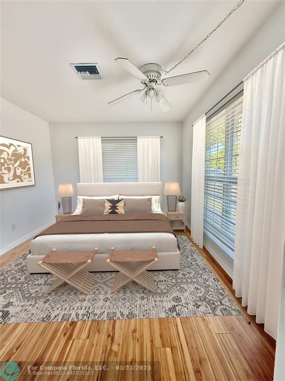 341 Southeast 8th Street Pompano Beach, FL 33060 - Photo 20 of 56 a spacious bedroom with a bed a rug and wooden floor