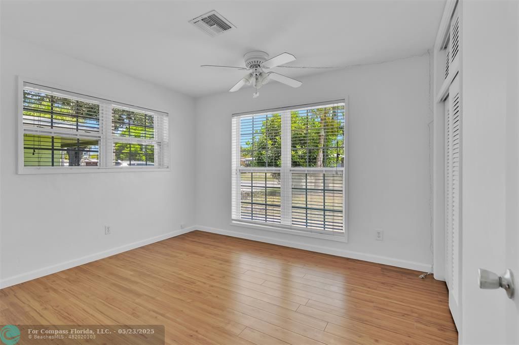 341 Southeast 8th Street Pompano Beach, FL 33060 - Photo 21 of 56 a view of an empty room with wooden floor and a window