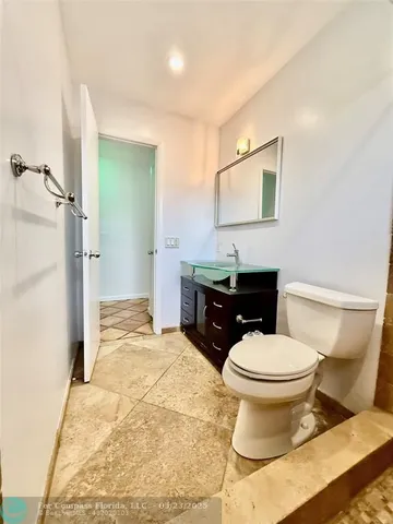 a view of a room with wooden floor and iron stairs