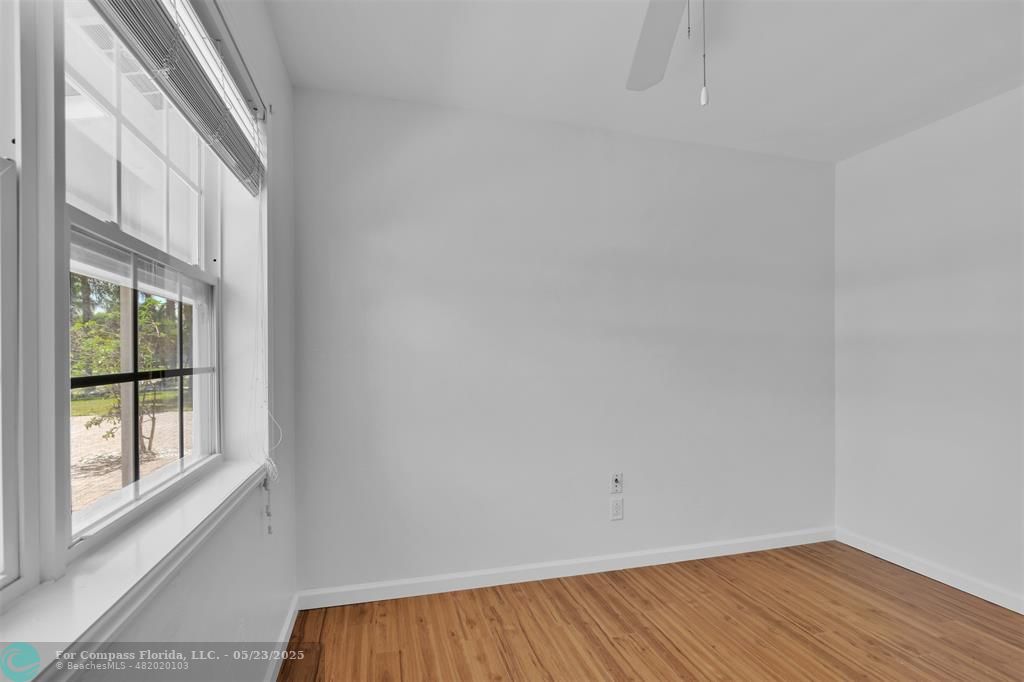 341 Southeast 8th Street Pompano Beach, FL 33060 - Photo 26 of 56 a view of a room with wooden floor and iron stairs