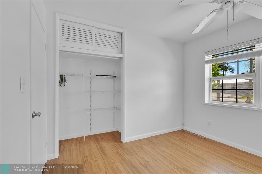 341 Southeast 8th Street Pompano Beach, FL 33060 - Photo 29 of 56 a view of an empty room with wooden floor and a window
