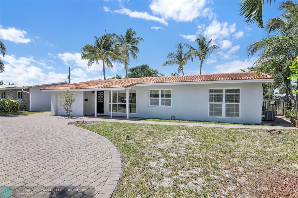 341 Southeast 8th Street Pompano Beach, FL 33060 - Photo 35 of 56 front view of a house with a yard and potted plants