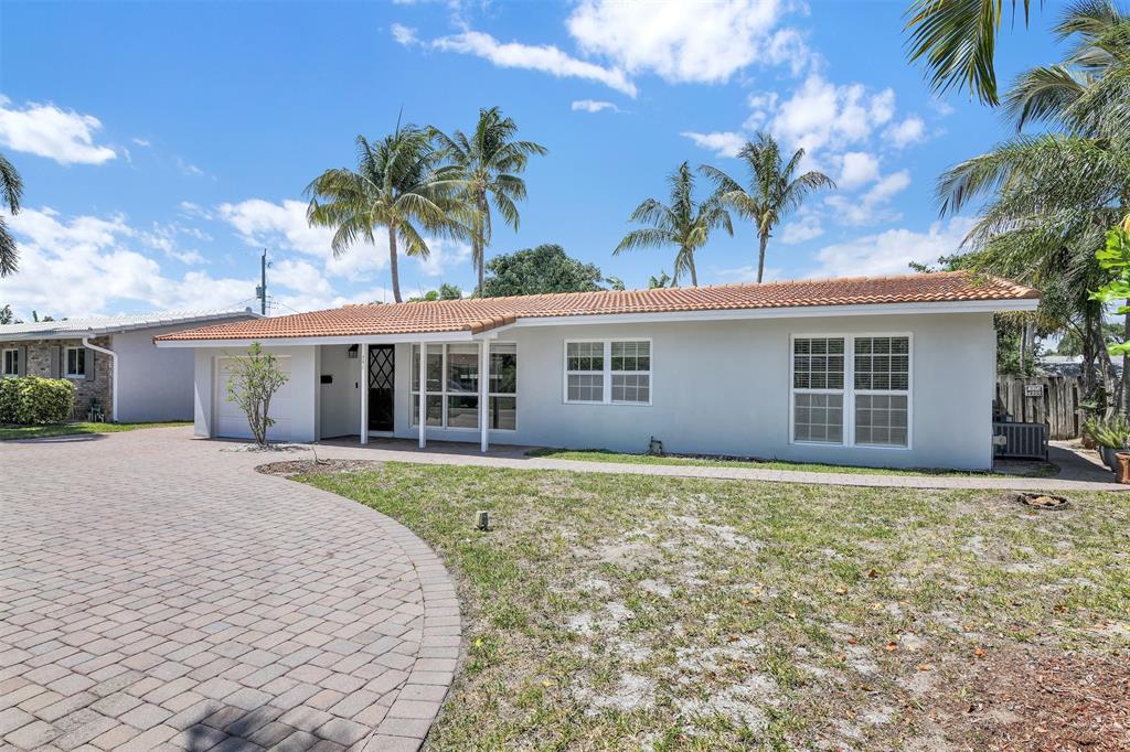 341 Southeast 8th Street Pompano Beach, FL 33060 - Photo 35 of 56 front view of a house with a yard and potted plants