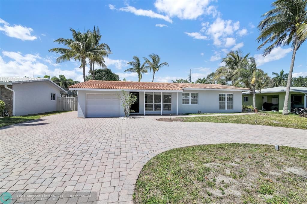 341 Southeast 8th Street Pompano Beach, FL 33060 - Photo 36 of 56 a front view of a house with a yard and garage