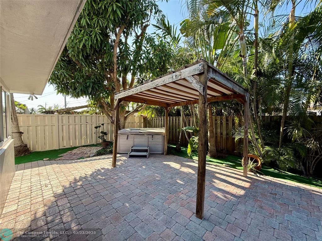 341 Southeast 8th Street Pompano Beach, FL 33060 - Photo 43 of 56 a view of a chair and table in backyard of house