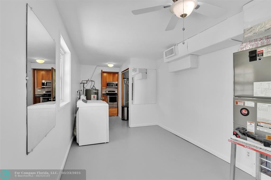 341 Southeast 8th Street Pompano Beach, FL 33060 - Photo 46 of 56 a living room with furniture and a chandelier