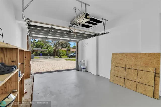 a view of a house with backyard and a tree