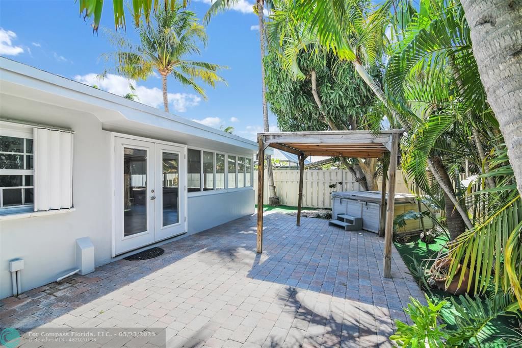341 Southeast 8th Street Pompano Beach, FL 33060 - Photo 49 of 56 a view of a patio with table and chairs potted plants