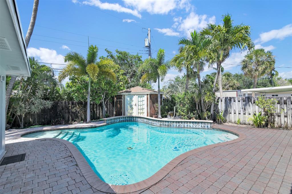 341 Southeast 8th Street Pompano Beach, FL 33060 - Photo 51 of 56 a view of a swimming pool with a patio