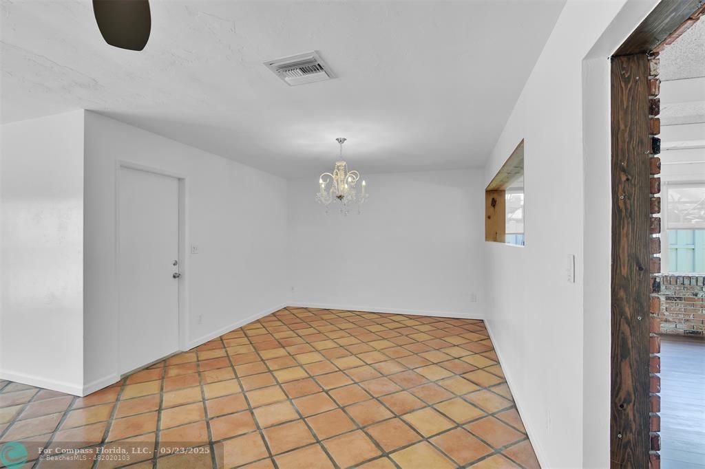 341 Southeast 8th Street Pompano Beach, FL 33060 - Photo 9 of 56 a view of a big room with wooden floor and windows