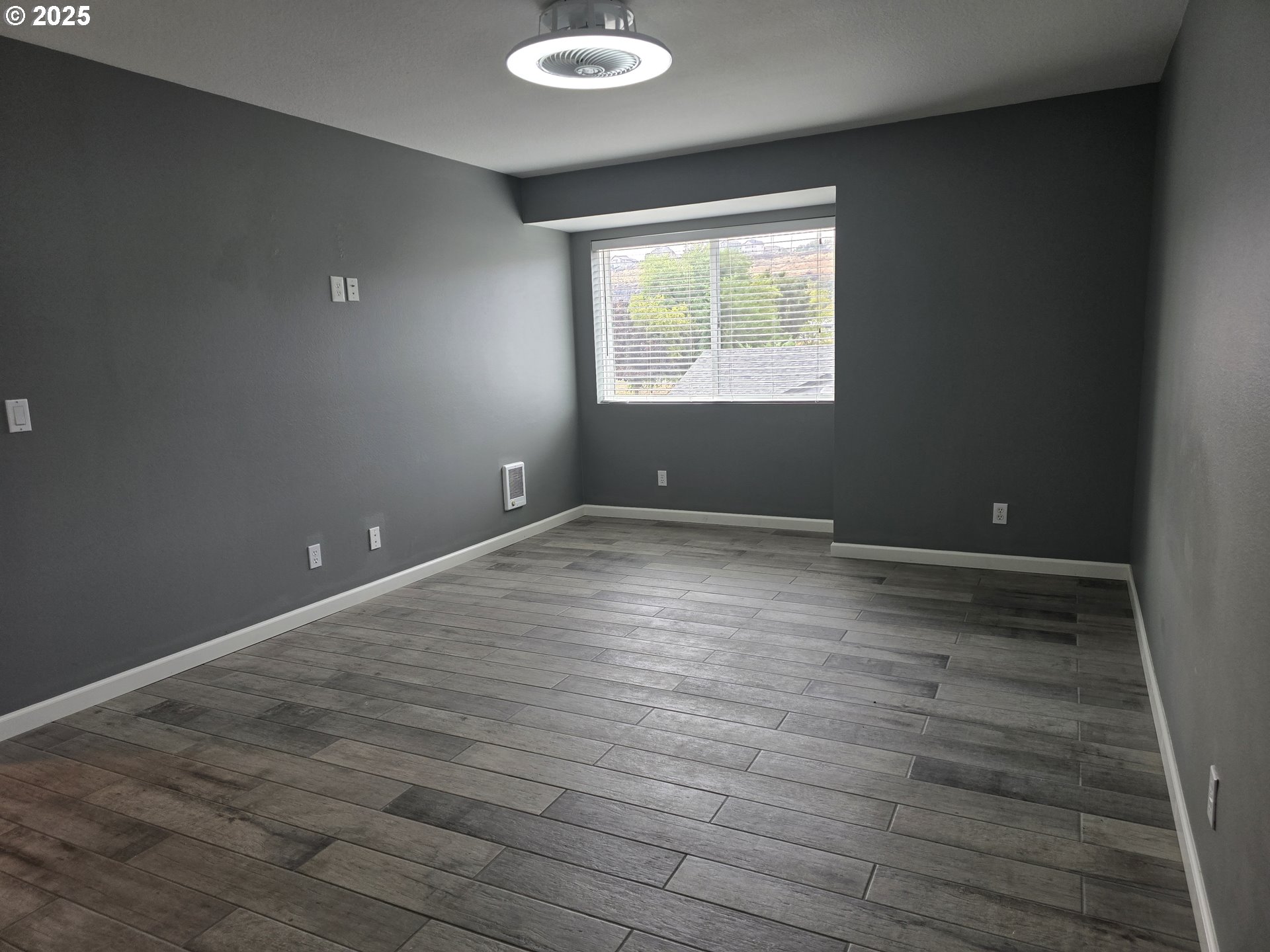 260 Lone Pine Lane, Unit 2 The Dalles, OR 97058 - Photo 11 of 23 an empty room with wooden floor and windows