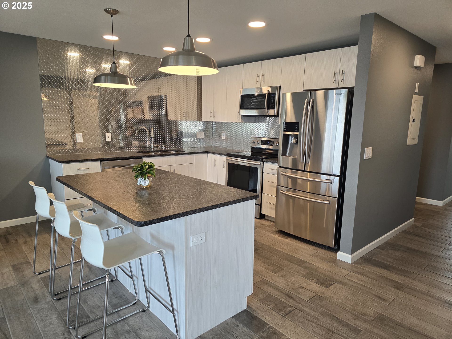 260 Lone Pine Lane, Unit 2 The Dalles, OR 97058 - Photo 2 of 23 a kitchen with kitchen island a counter top space a sink appliances and cabinets