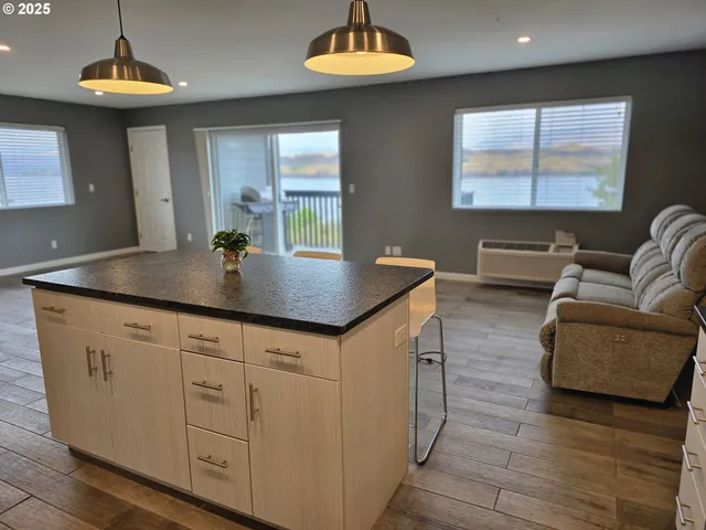 a kitchen with stainless steel appliances granite countertop a sink a window and a counter space