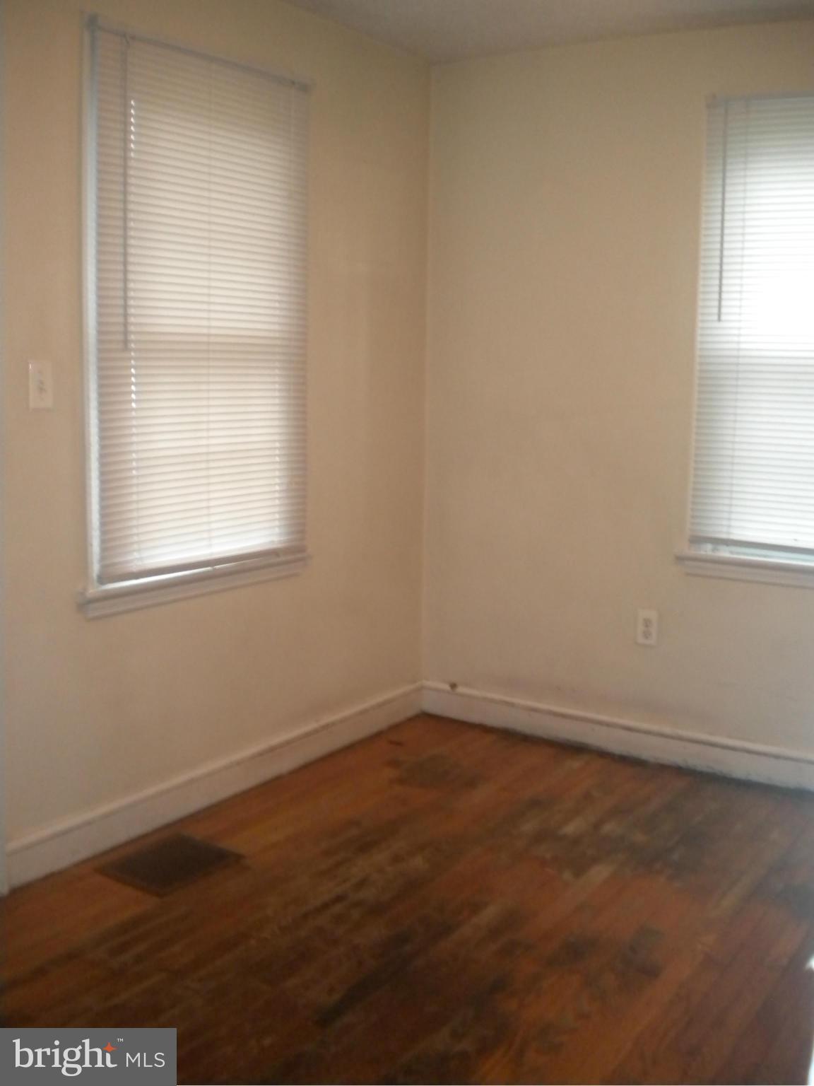 2 Patapsco Road Linthicum Heights, MD 21090 - Photo 4 of 12 an empty room with wooden floor and windows