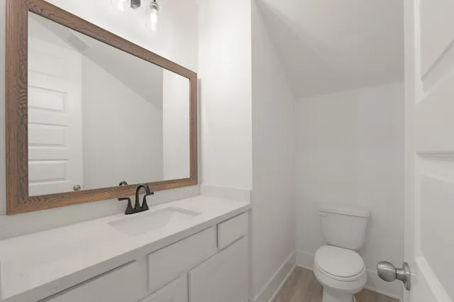 a bathroom with a sink a toilet and a mirror