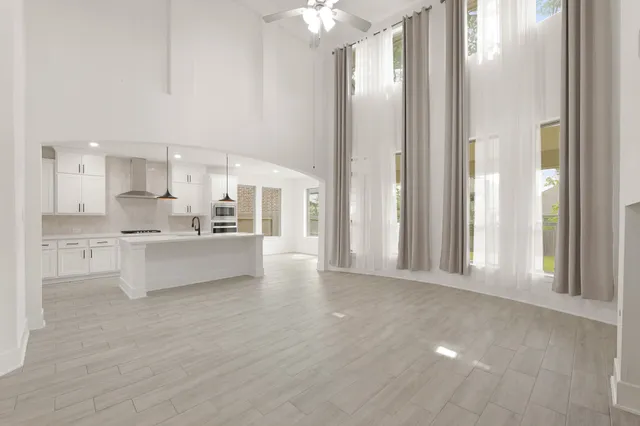 a view of kitchen with windows and refrigerator