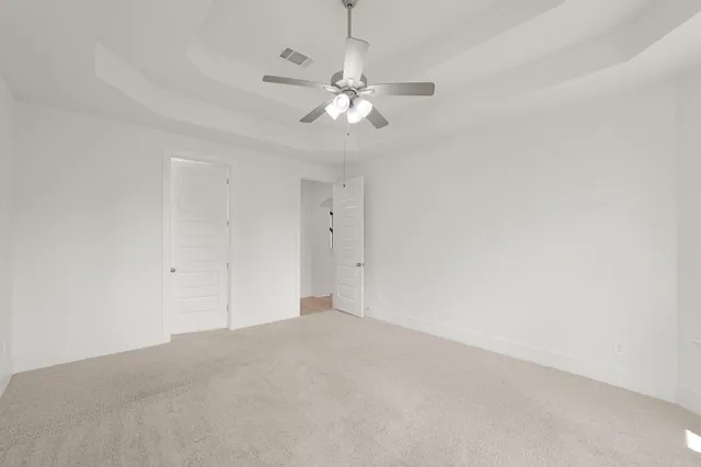 a view of a chandelier fan in big room