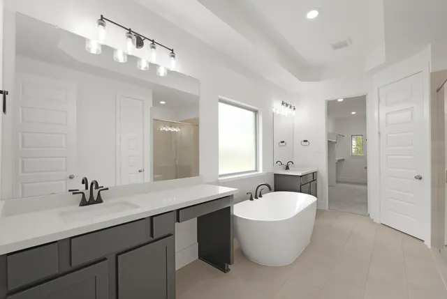 a bathroom with a double vanity sink and mirror