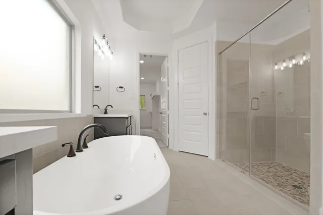 a bathroom with a bathtub and a shower
