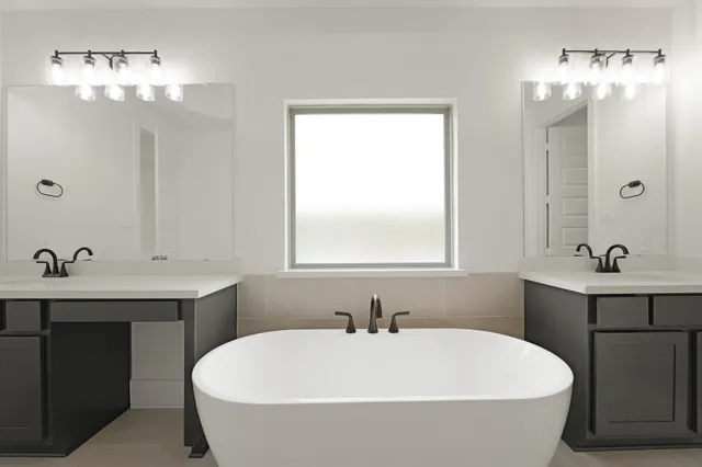 a bathroom with a bathtub a sink and mirror