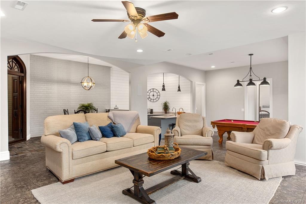 65 Waterhill Way Fletcher, NC 28732 - Photo 35 of 48 a living room with furniture and a chandelier