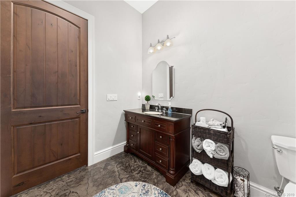 65 Waterhill Way Fletcher, NC 28732 - Photo 42 of 48 a room with round mirror and cabinets