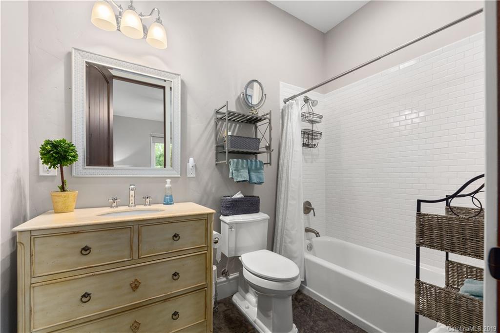 65 Waterhill Way Fletcher, NC 28732 - Photo 46 of 48 a bathroom with a double vanity sink toilet mirror and bathtub