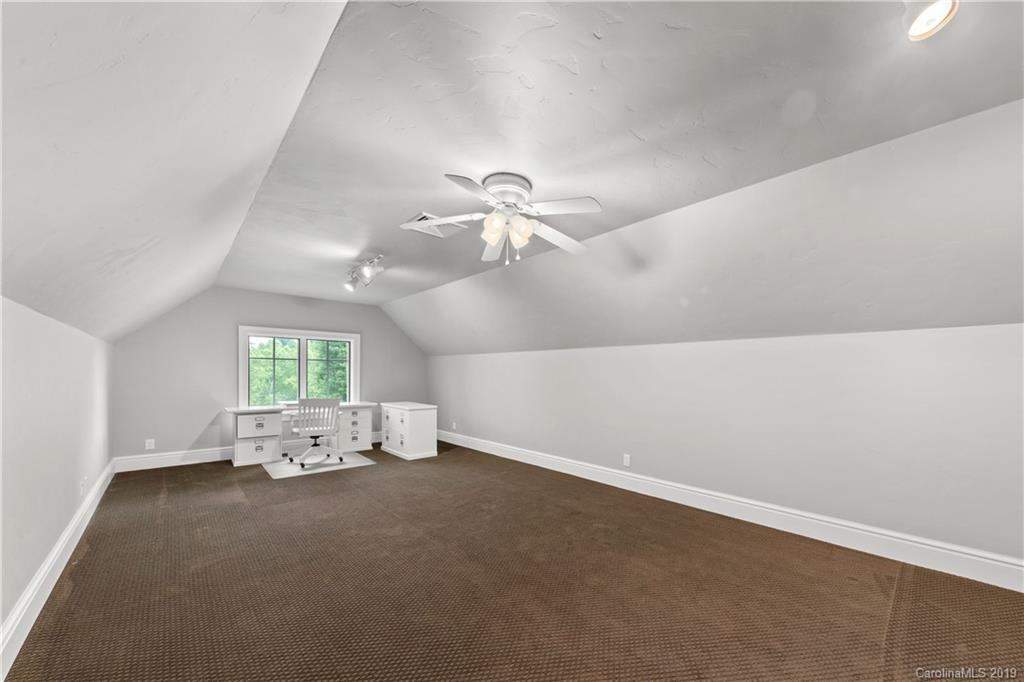 65 Waterhill Way Fletcher, NC 28732 - Photo 47 of 48 an empty room with chandelier fan and windows