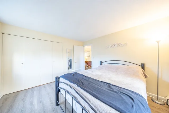 a room with a bed and wooden floor