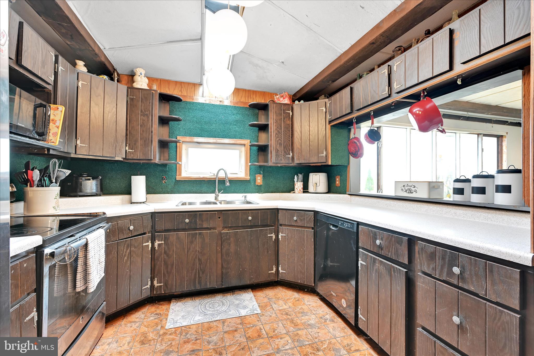 389 Sweet Arrow Lake Road Pine Grove, PA 17963 - Photo 32 of 59 a kitchen with stainless steel appliances granite countertop a sink and cabinets