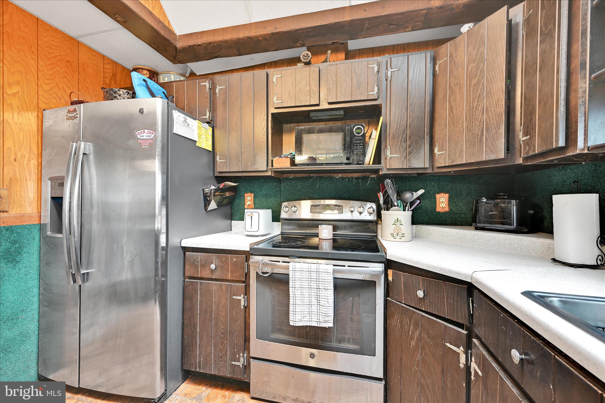 389 Sweet Arrow Lake Road Pine Grove, PA 17963 - Photo 34 of 59 a kitchen with stainless steel appliances granite countertop a refrigerator a stove and a sink with wooden floor