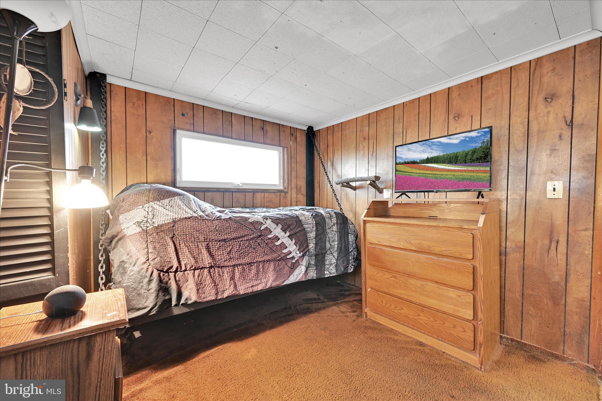 389 Sweet Arrow Lake Road Pine Grove, PA 17963 - Photo 42 of 59 a bedroom with a bed and large window