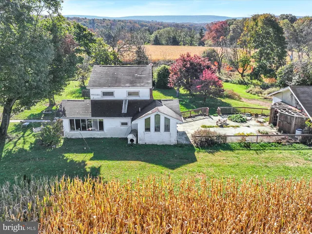 a aerial view of a house with a garden and a yard